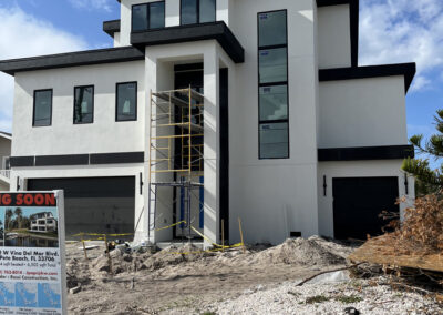 Contemporary three-story custom home with black-and-white modern exterior and large vertical window walls