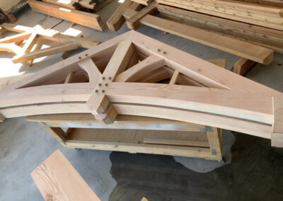Stack of newly fabricated wood roof trusses staged at the shop yard.