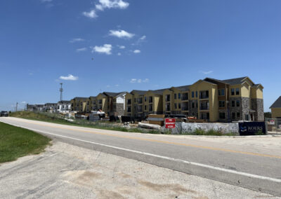 Completed multi-family apartment community exterior with multiple residential buildings and surrounding parking.
