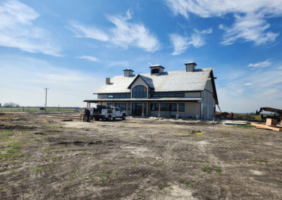 Completed Johns Longhorn Station commercial building with a standing-seam metal roof over timber-trussed construction.